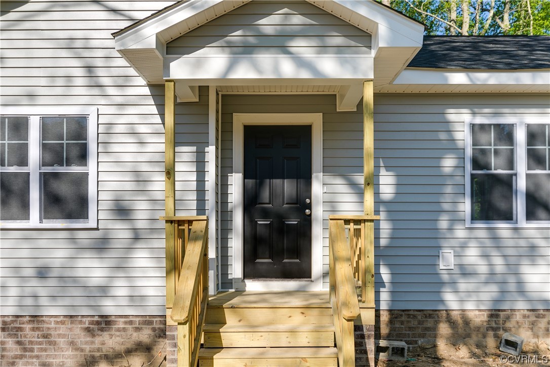 15318 Saddlebrook Road Chesterfield, VA 23838 - Photo 5 of 10 a front view of a house with a glass windows