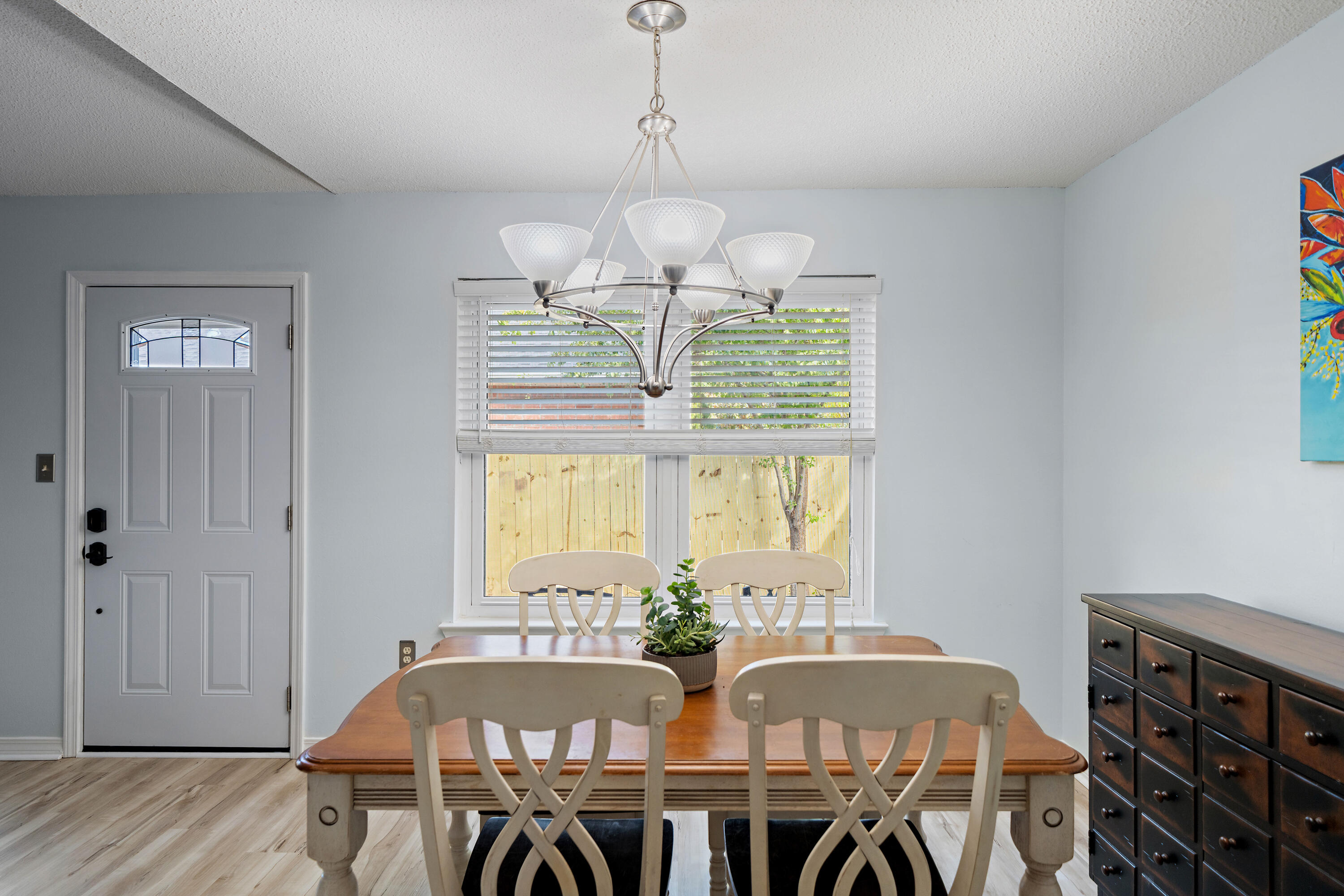 3879 Mesa Road Destin, FL 32541 - Photo 11 of 27 a view of a dining room with furniture window and wooden floor
