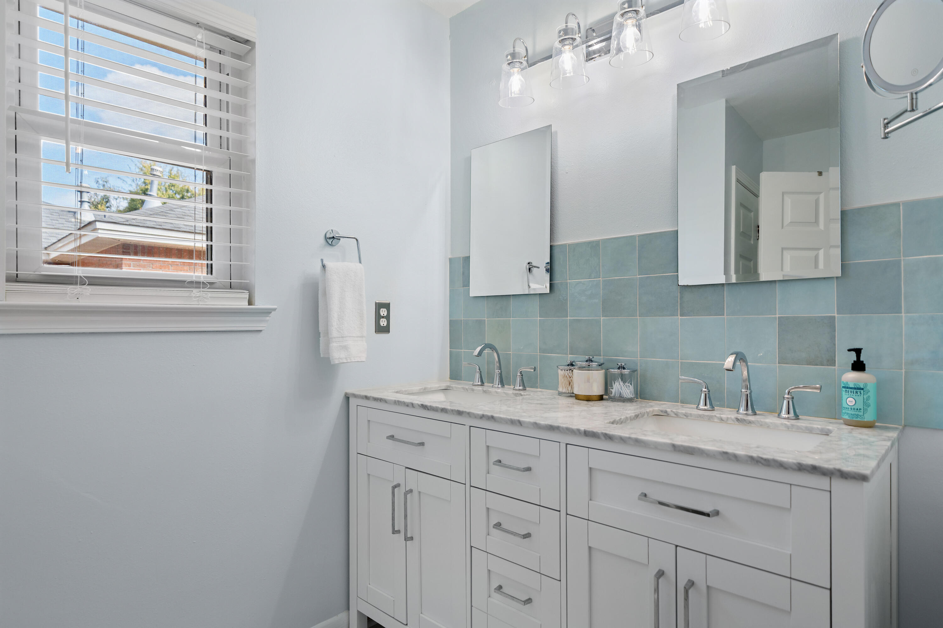 3879 Mesa Road Destin, FL 32541 - Photo 16 of 27 a kitchen with white cabinets and a window