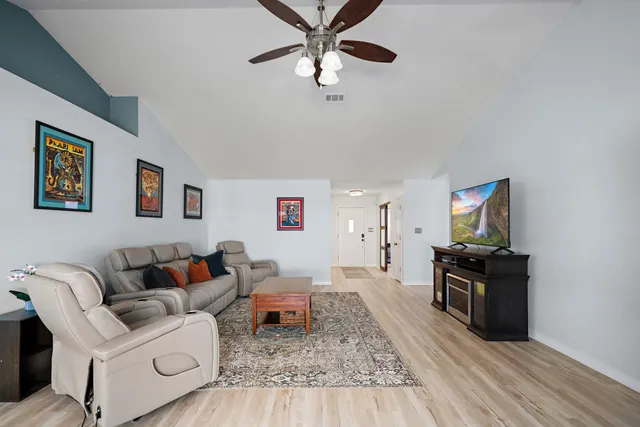 a living room with furniture and wooden floor