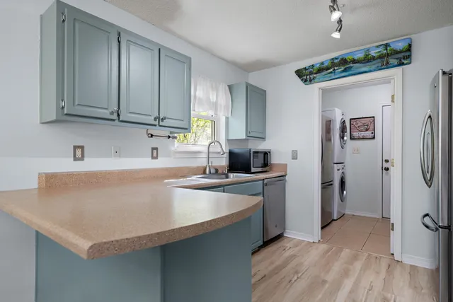 a kitchen with stainless steel appliances a sink stove and refrigerator