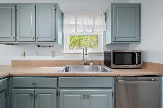 a kitchen with appliances cabinets and a counter top space