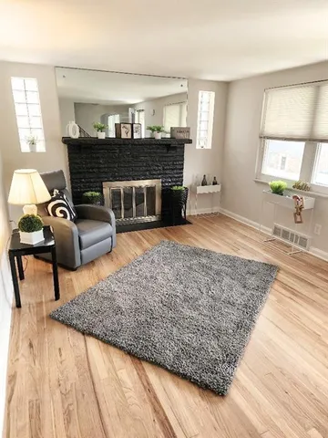 a living room with furniture and a fireplace