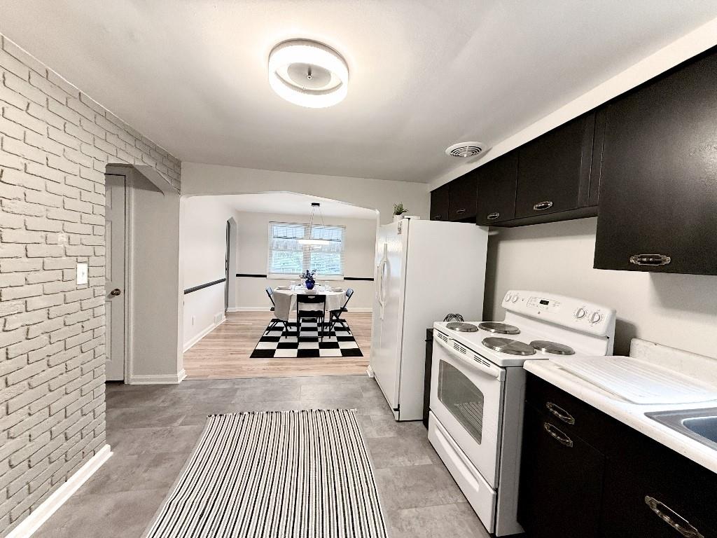 1320 Main Street Bridgeville, PA 15017 - Photo 9 of 26 a kitchen with a refrigerator and a stove top oven