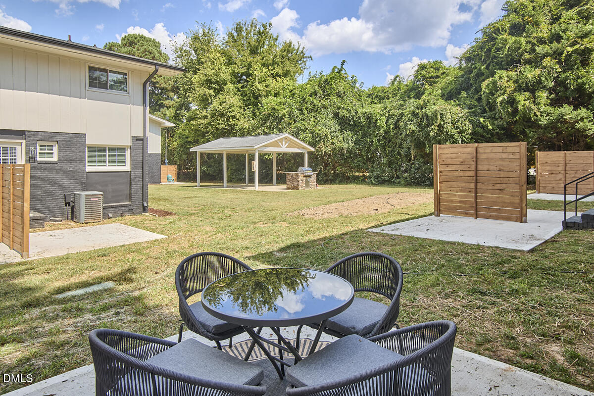 2613 McNeil Street, Unit B Raleigh, NC 27608 - Photo 30 of 31 a view of a patio with table and chairs with wooden floor and fence