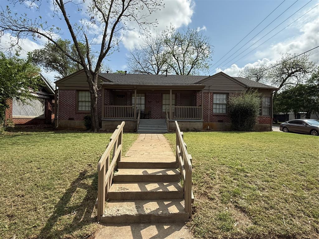 Single story home featuring crawl space, a porch, a front lawn, and brick siding