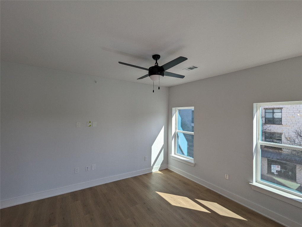 2500 Longview Street, Unit 322 Austin, TX 78705 - Photo 11 of 25 wooden floor in an empty room with a window