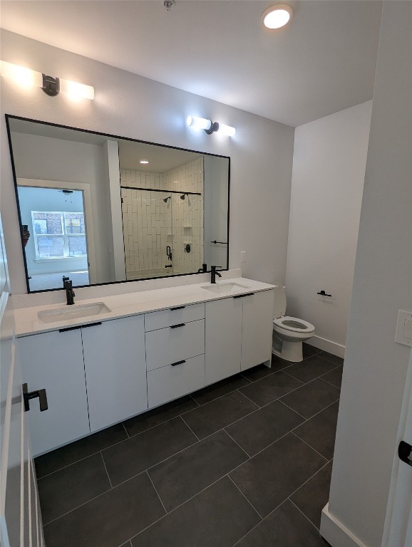 2500 Longview Street, Unit 322 Austin, TX 78705 - Photo 12 of 25 a bathroom with a double vanity sink a mirror and a toilet