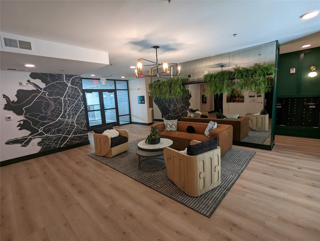 2500 Longview Street, Unit 322 Austin, TX 78705 - Photo 3 of 25 a living room with furniture a flat screen tv and a floor to ceiling window