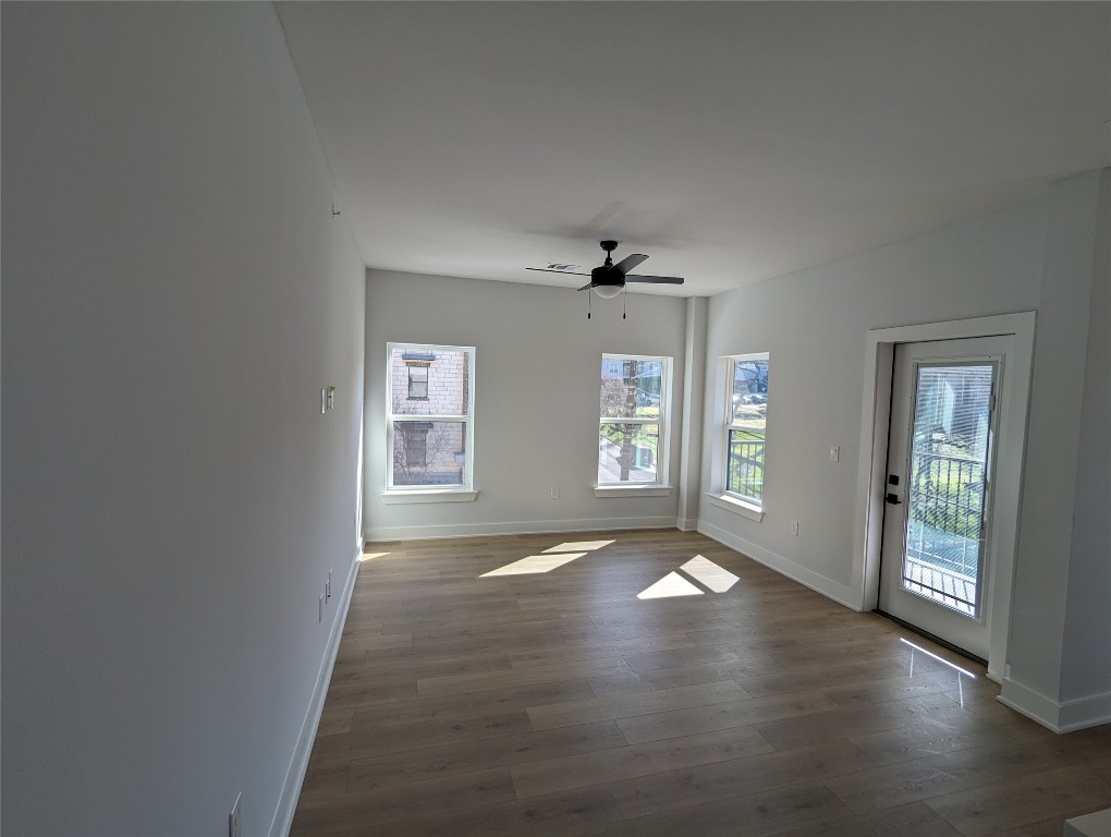 2500 Longview Street, Unit 322 Austin, TX 78705 - Photo 7 of 25 an empty room with wooden floor and windows