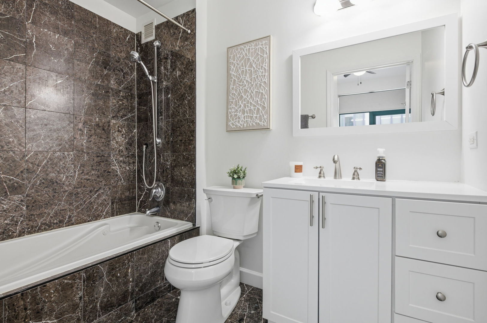 340 West Superior Street, Unit 1009 Chicago, IL 60654 - Photo 11 of 24 a bathroom with a sink toilet and shower