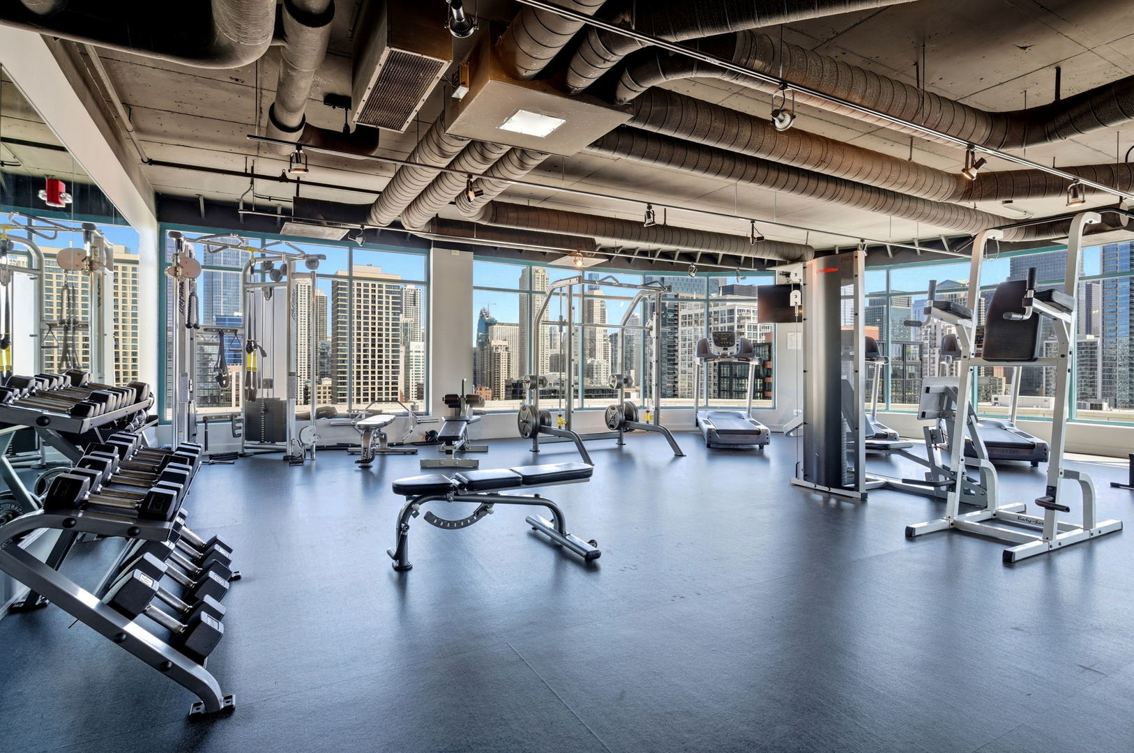 340 West Superior Street, Unit 1009 Chicago, IL 60654 - Photo 18 of 24 a gym room with lots of furniture and a large window