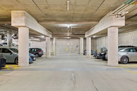 a view of parking garage with cars