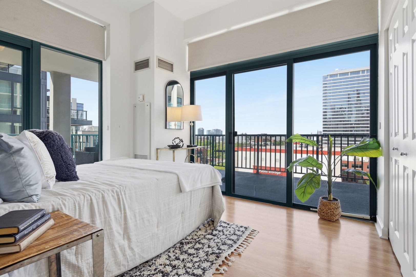 340 West Superior Street, Unit 1009 Chicago, IL 60654 - Photo 4 of 24 a bed sitting in a bedroom next to a window