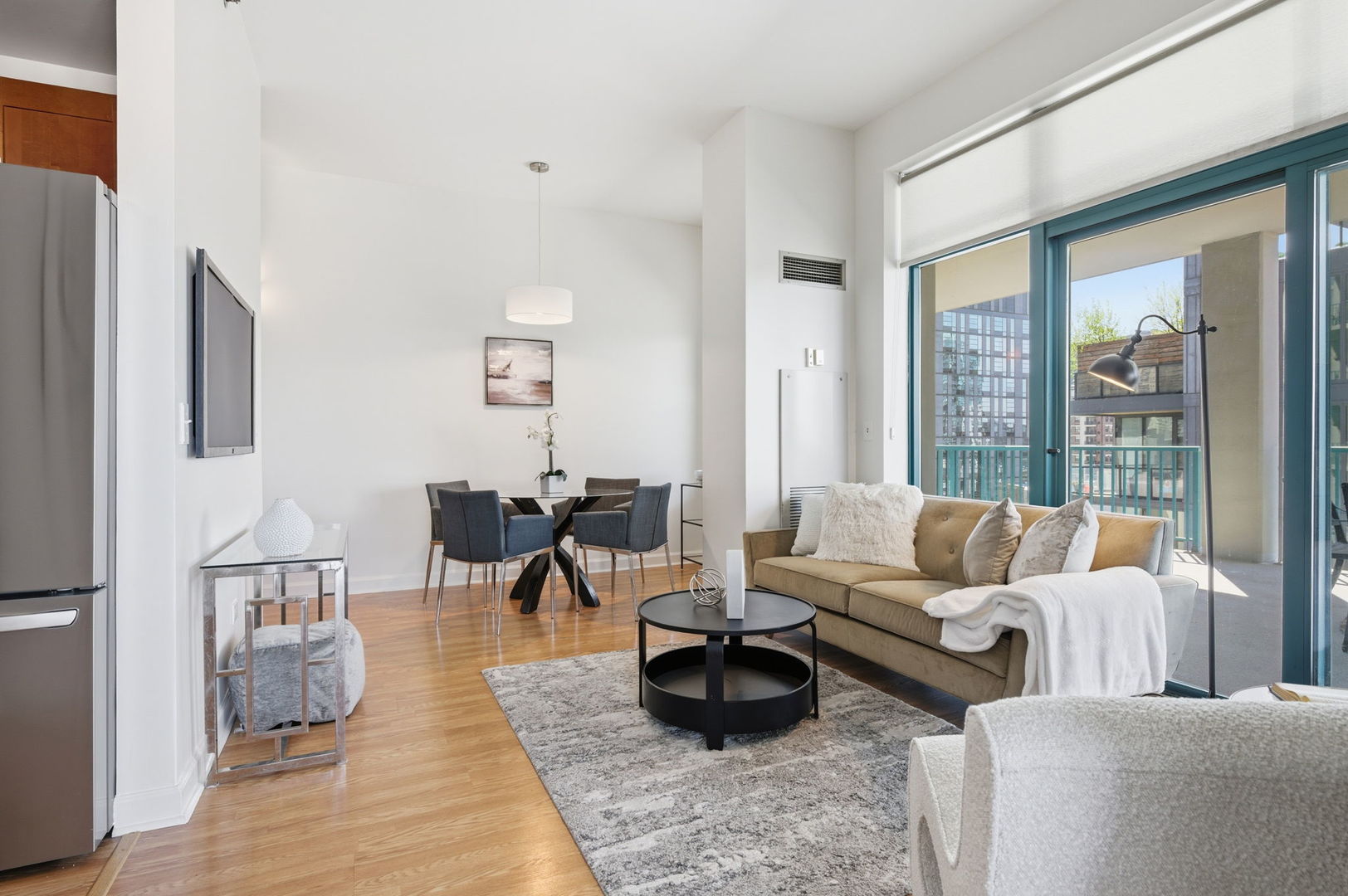340 West Superior Street, Unit 1009 Chicago, IL 60654 - Photo 6 of 24 a living room with furniture wooden floor and a large window