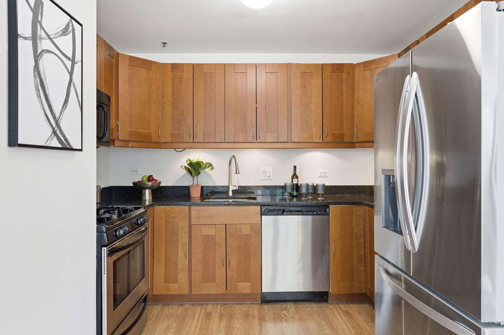 340 West Superior Street, Unit 1009 Chicago, IL 60654 - Photo 8 of 24 a kitchen with granite countertop a refrigerator stove and sink
