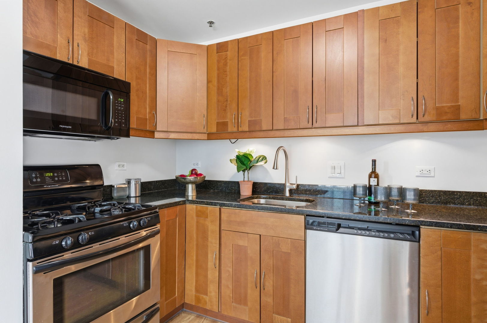 340 West Superior Street, Unit 1009 Chicago, IL 60654 - Photo 9 of 24 a kitchen with granite countertop a stove sink and cabinets