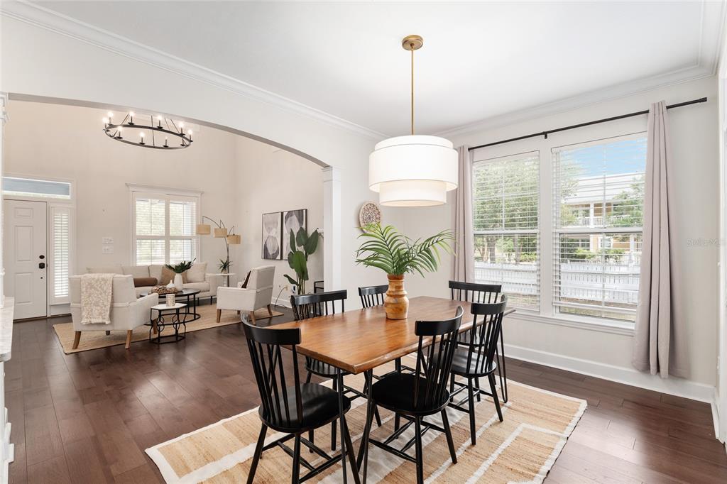 303 Southwest 129 Terrace Newberry, FL 32669 - Photo 12 of 75 a view of a dining room and livingroom with furniture wooden floor a chandelier