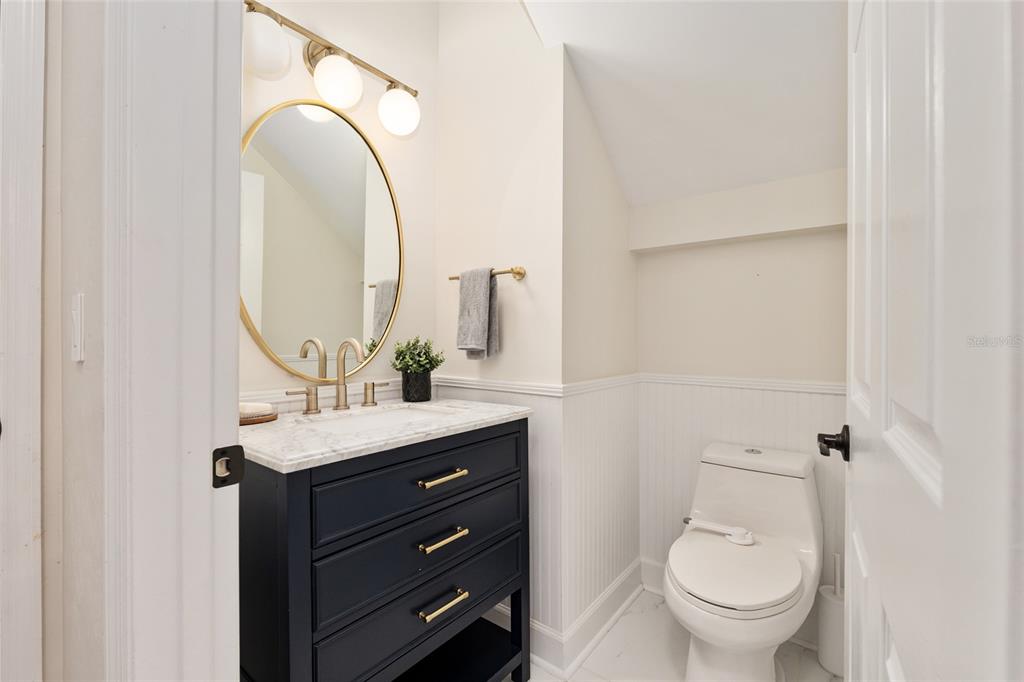 303 Southwest 129 Terrace Newberry, FL 32669 - Photo 25 of 75 a bathroom with a granite countertop toilet sink and mirror
