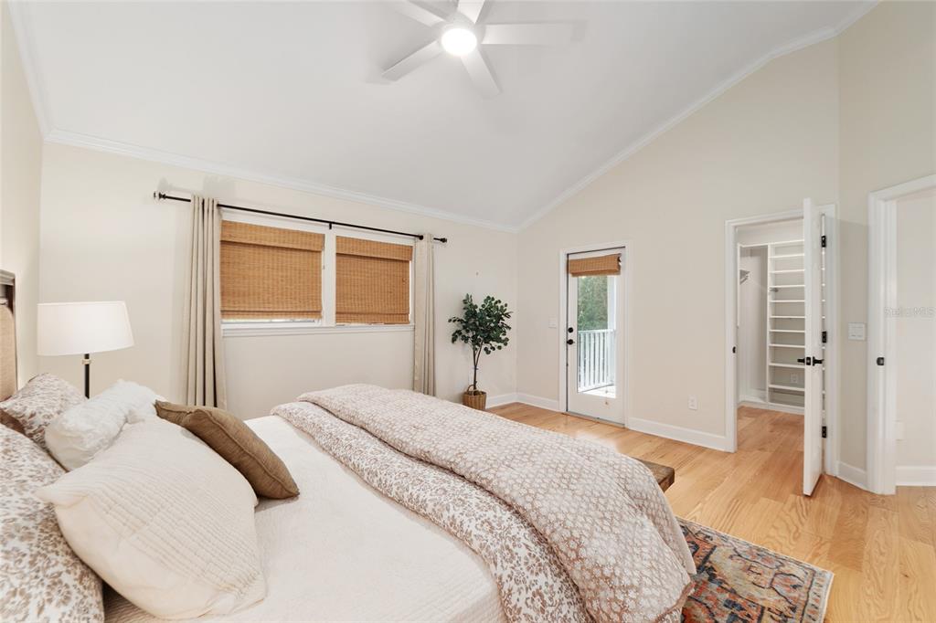 303 Southwest 129 Terrace Newberry, FL 32669 - Photo 29 of 75 a bedroom with a large bed a chandelier and a dresser