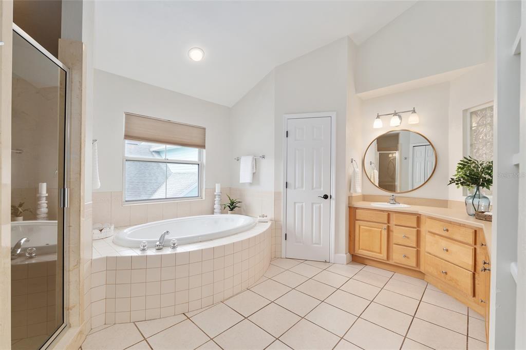 303 Southwest 129 Terrace Newberry, FL 32669 - Photo 30 of 75 a spacious bathroom with a mirror a bathtub and a sink