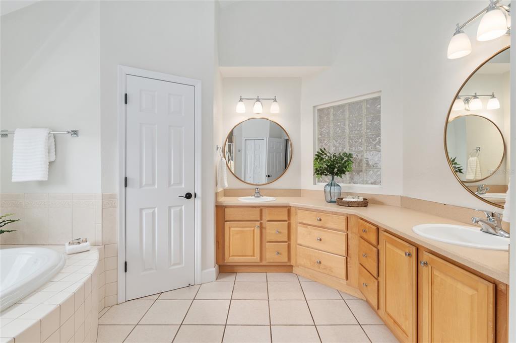 303 Southwest 129 Terrace Newberry, FL 32669 - Photo 31 of 75 a spacious bathroom with a granite countertop sink mirror and bathtub