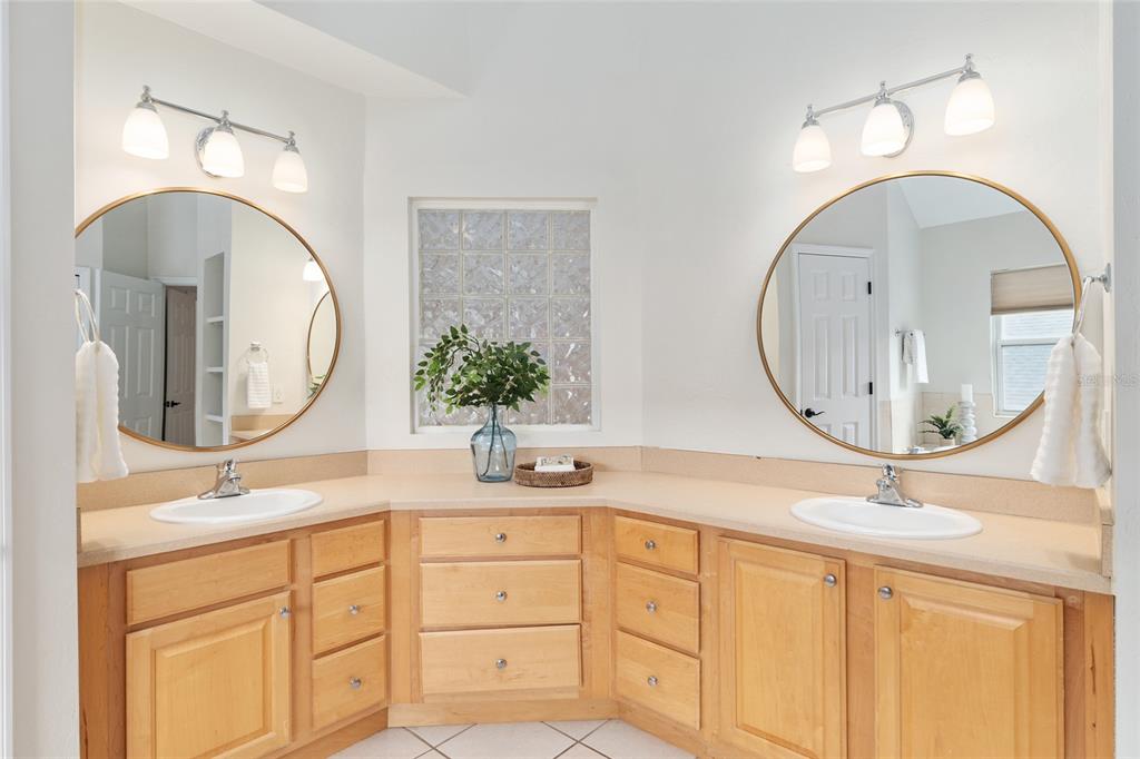 303 Southwest 129 Terrace Newberry, FL 32669 - Photo 32 of 75 a bathroom with a double vanity sink and a mirror