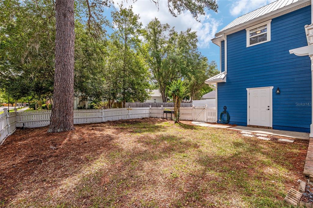 303 Southwest 129 Terrace Newberry, FL 32669 - Photo 52 of 75 a backyard of a house with a tree and wooden fence