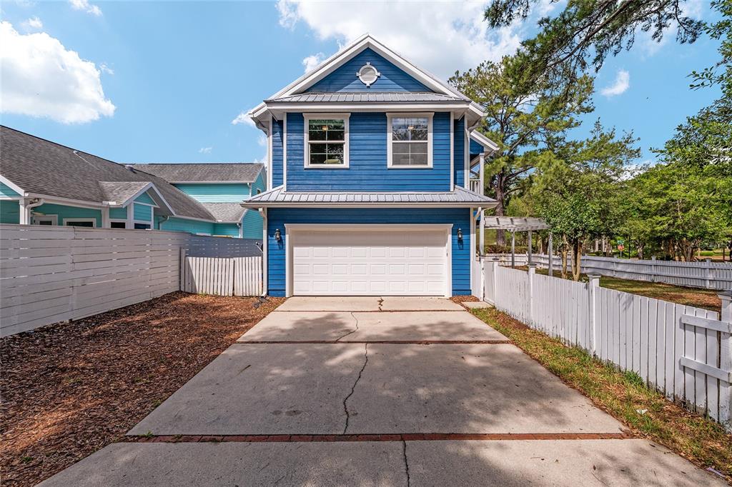 303 Southwest 129 Terrace Newberry, FL 32669 - Photo 59 of 75 a front view of a house with a yard and garage