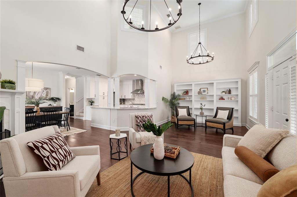 303 Southwest 129 Terrace Newberry, FL 32669 - Photo 6 of 75 a living room with furniture kitchen view and a chandelier