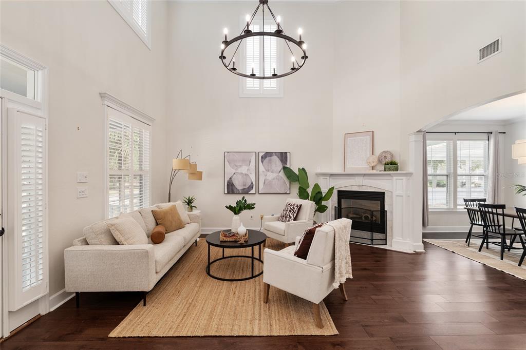 303 Southwest 129 Terrace Newberry, FL 32669 - Photo 7 of 75 a living room with furniture a fireplace and a floor to ceiling window