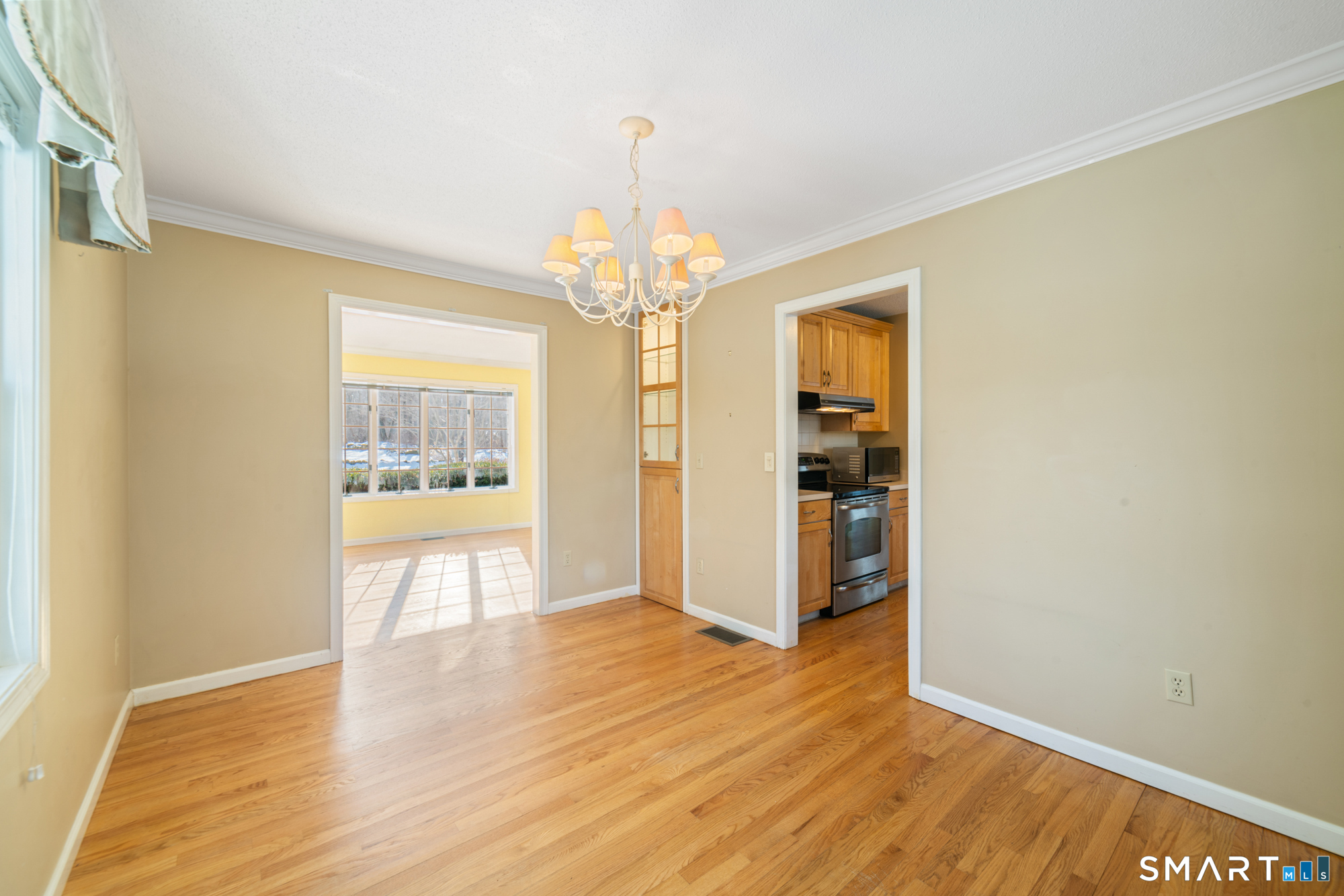 165 Garrigus Court Wolcott, CT 06716 - Photo 16 of 40 a view of an empty room with wooden floor and a window