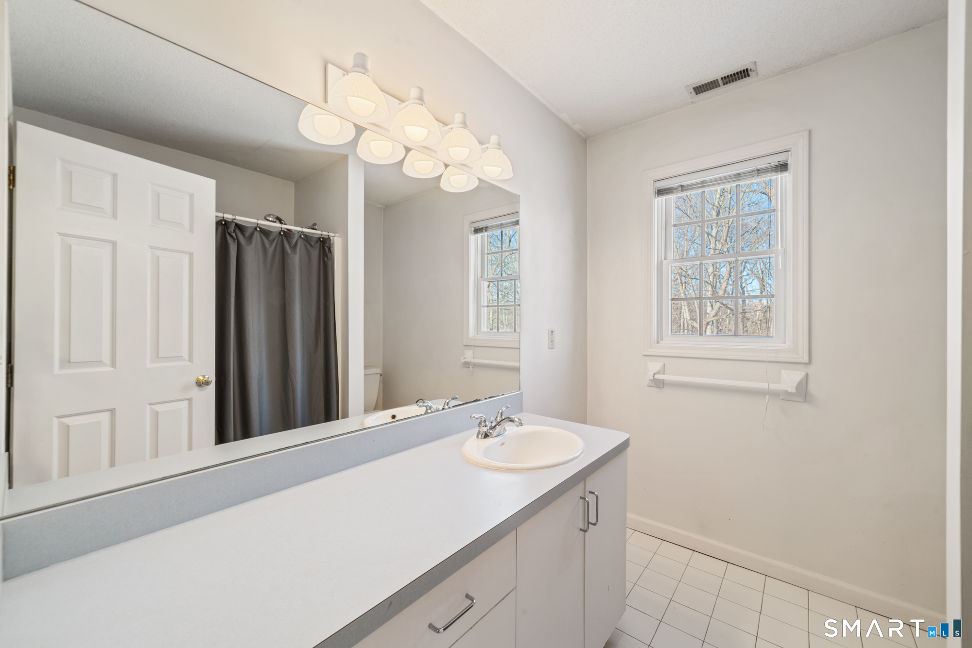 165 Garrigus Court Wolcott, CT 06716 - Photo 27 of 40 a bathroom with a sink vanity and a mirror