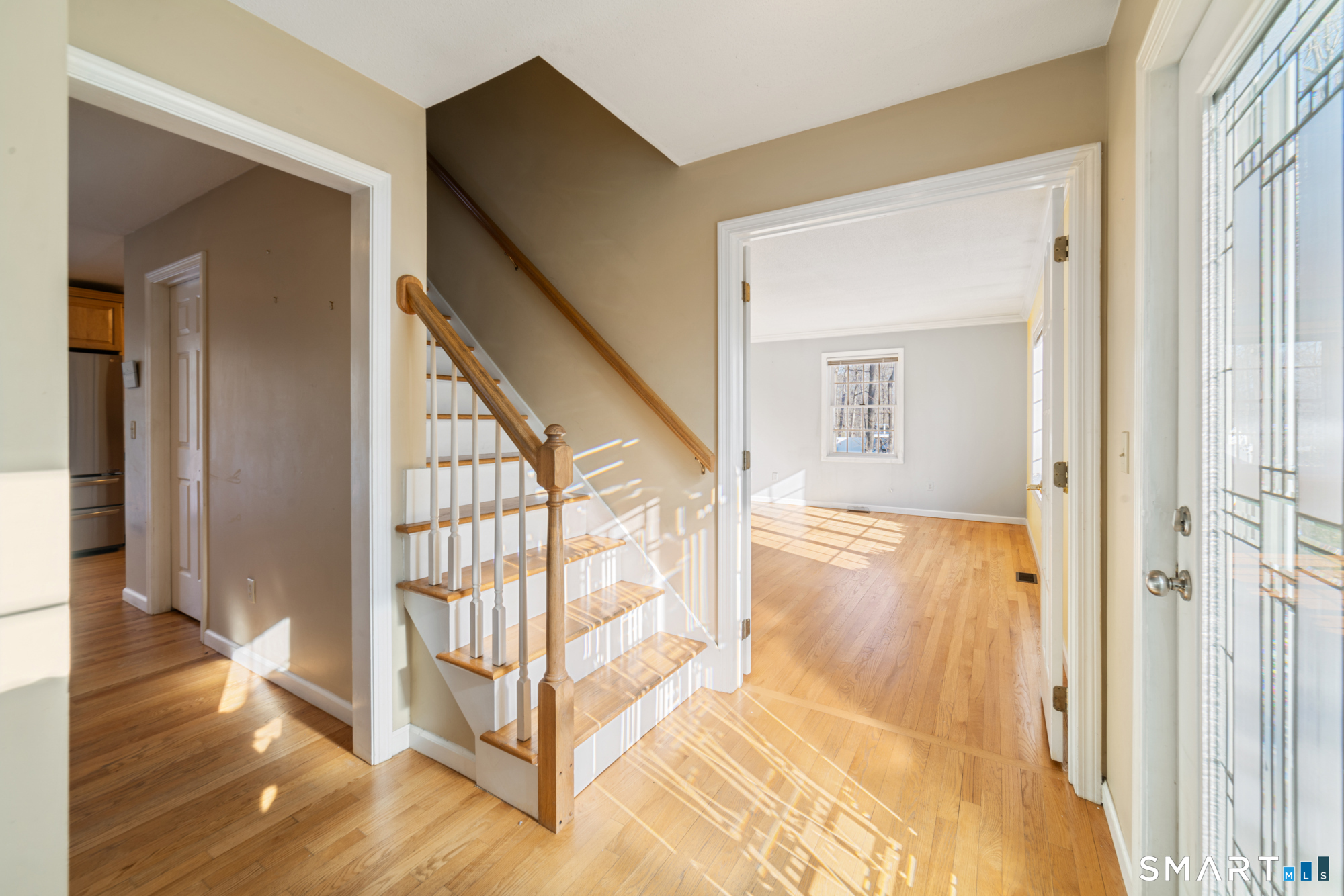 165 Garrigus Court Wolcott, CT 06716 - Photo 3 of 40 a view of a hallway with wooden floor and door