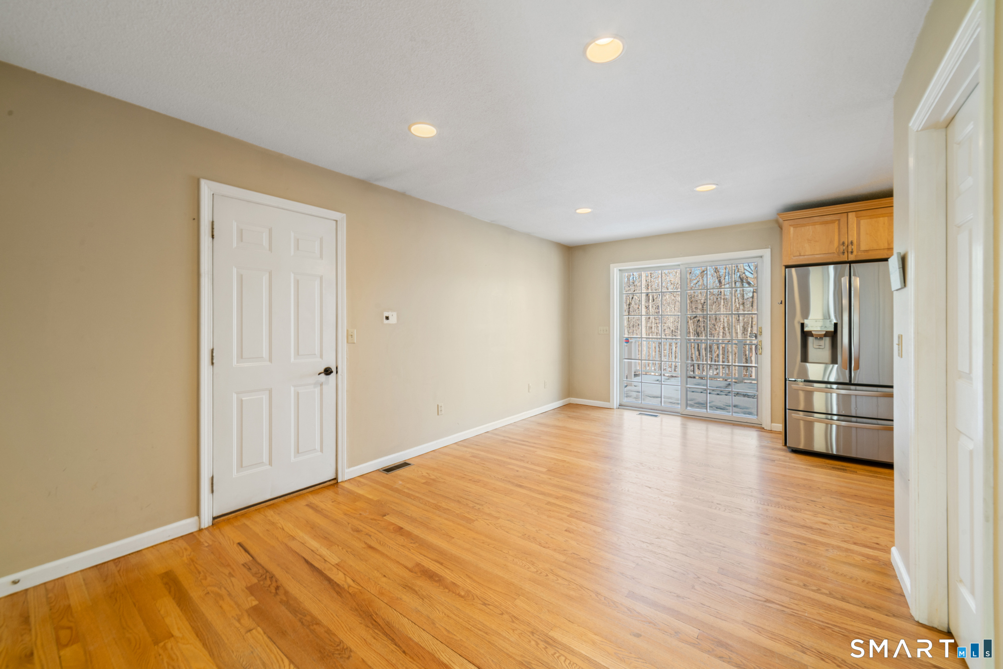 165 Garrigus Court Wolcott, CT 06716 - Photo 5 of 40 a view of an empty room with wooden floor and a window