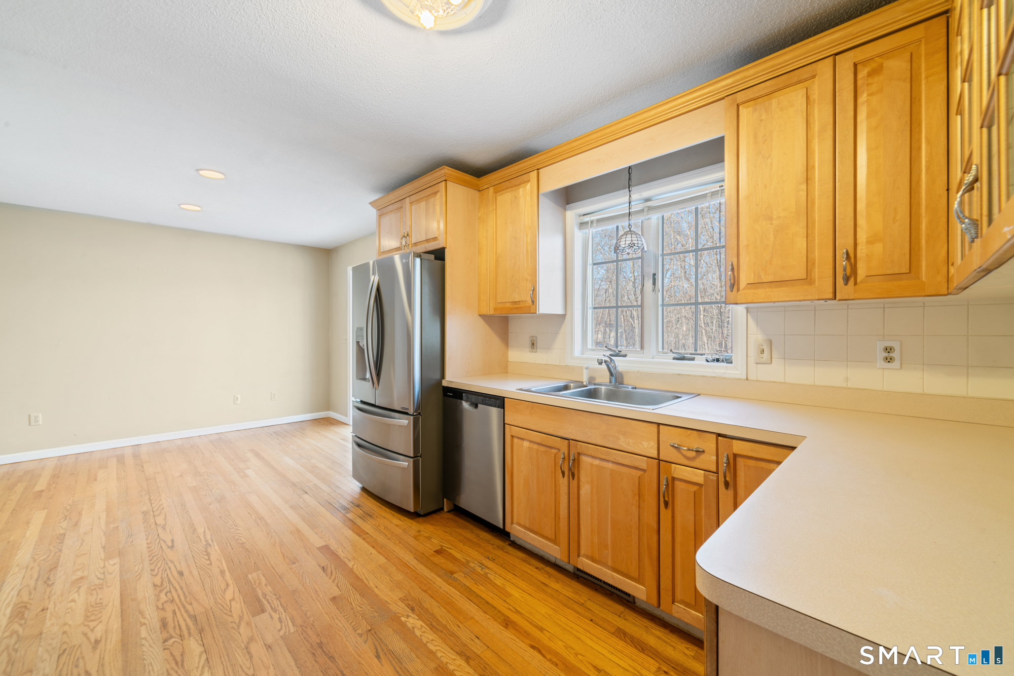 165 Garrigus Court Wolcott, CT 06716 - Photo 10 of 40 a kitchen with a refrigerator sink and cabinets