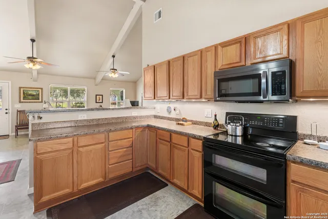 a kitchen with a sink stove and microwave
