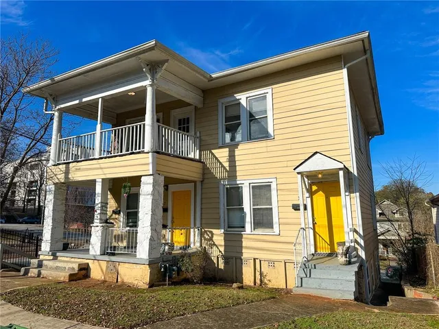 a view of a brick house with large windows