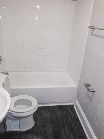 a bathroom with a toilet and a bathtub