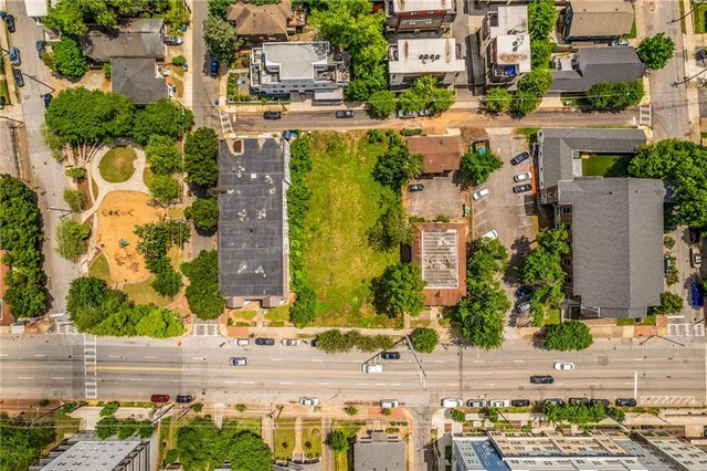 an aerial view of residential houses with outdoor space