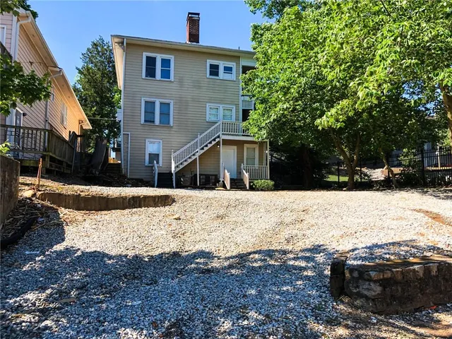 a view of a yard covered with snow in front of house