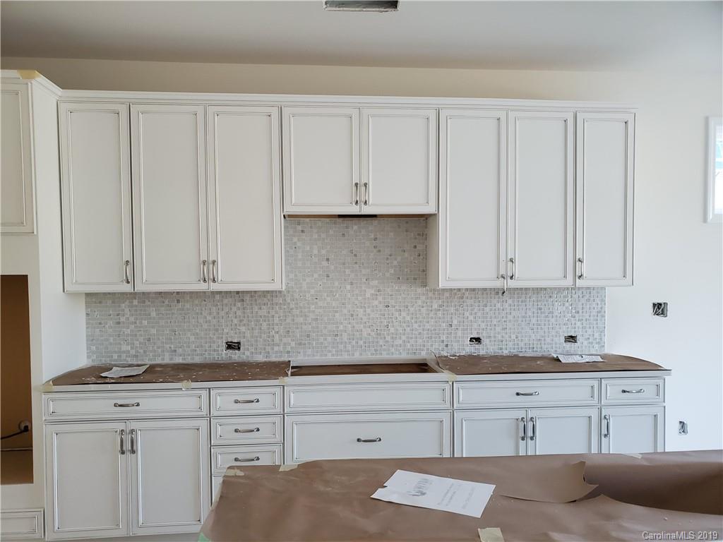 5505 Braddock Ml Way, Unit 273 Lancaster, SC 29720 - Photo 12 of 29 a kitchen with granite countertop white cabinets and white appliances