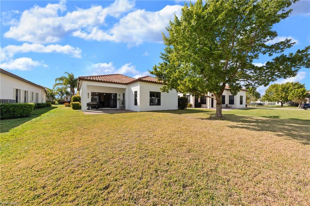 5172 Bergamo Way Ave Maria, FL 34142 - Photo 24 of 33 a front view of a house with a yard