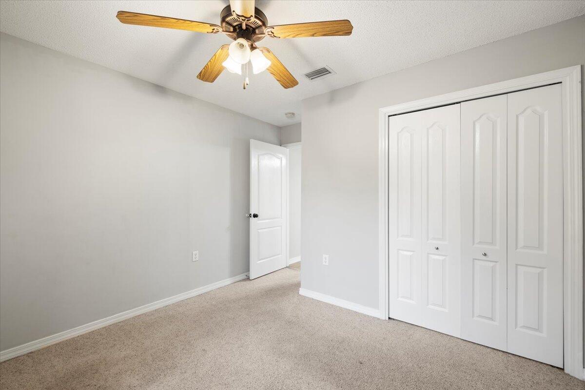 3140 Skyline Drive Crestview, FL 32539 - Photo 12 of 29 an empty room with windows and fan