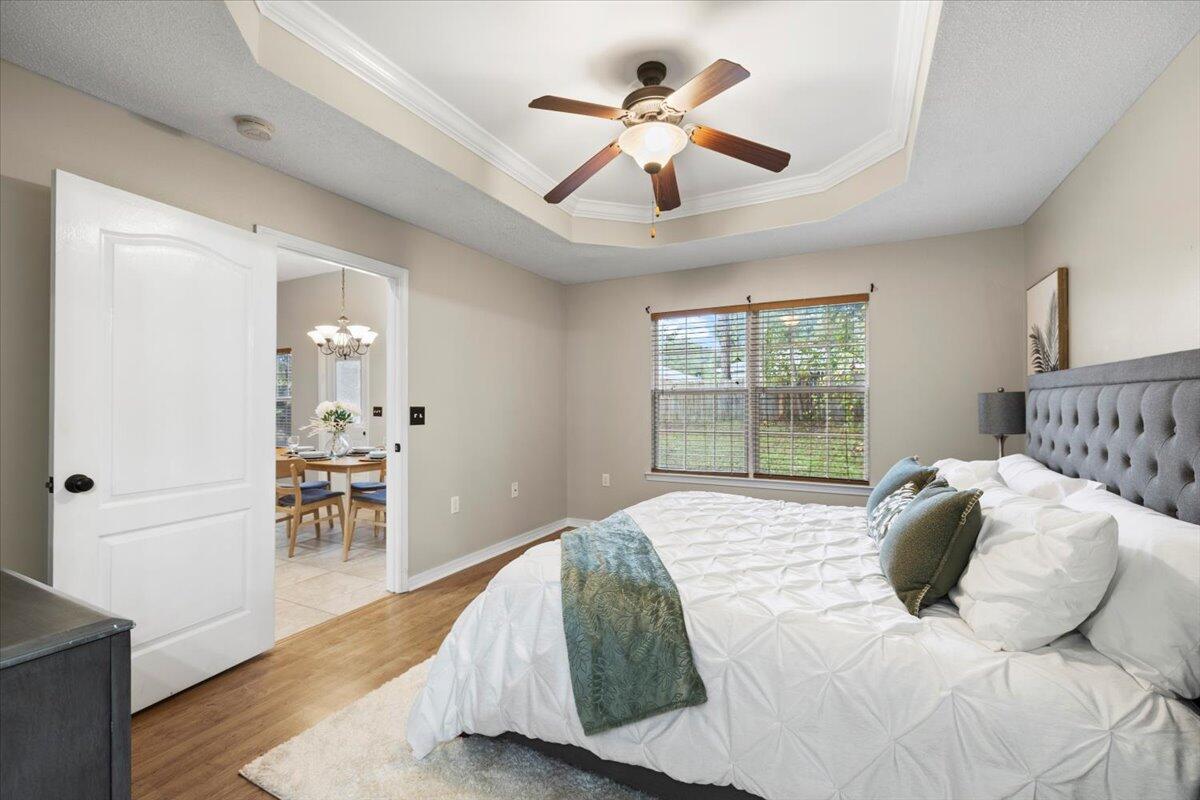 3140 Skyline Drive Crestview, FL 32539 - Photo 14 of 29 a bedroom with a large bed and a chandelier