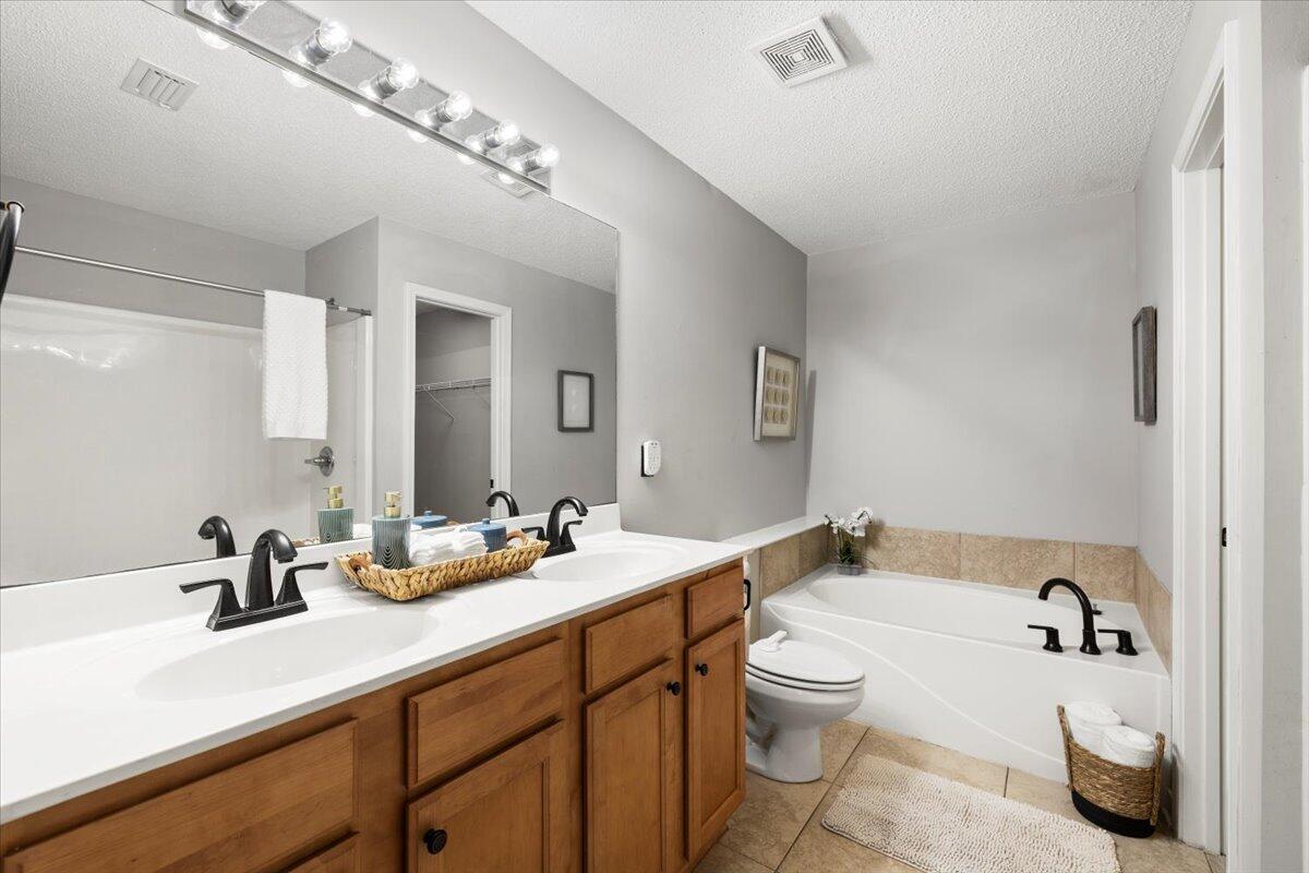 3140 Skyline Drive Crestview, FL 32539 - Photo 15 of 29 a bathroom with a double vanity sink toilet and shower