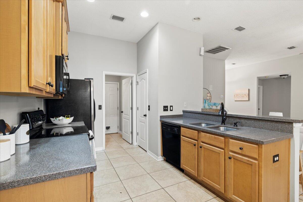 3140 Skyline Drive Crestview, FL 32539 - Photo 17 of 29 a kitchen with stainless steel appliances granite countertop a sink stove and refrigerator