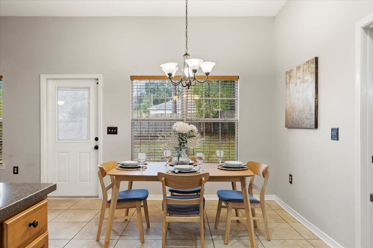 3140 Skyline Drive Crestview, FL 32539 - Photo 23 of 29 a dining room with furniture a chandelier and window