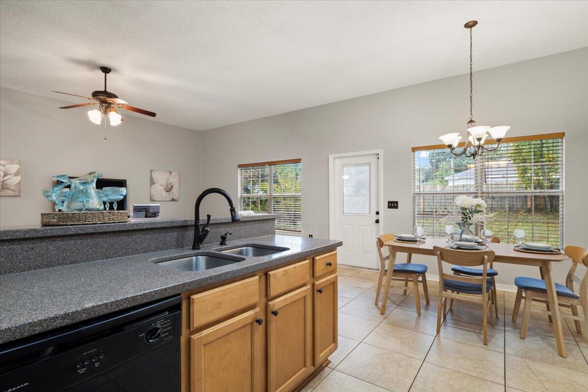 3140 Skyline Drive Crestview, FL 32539 - Photo 24 of 29 a kitchen with a table chairs and chandelier