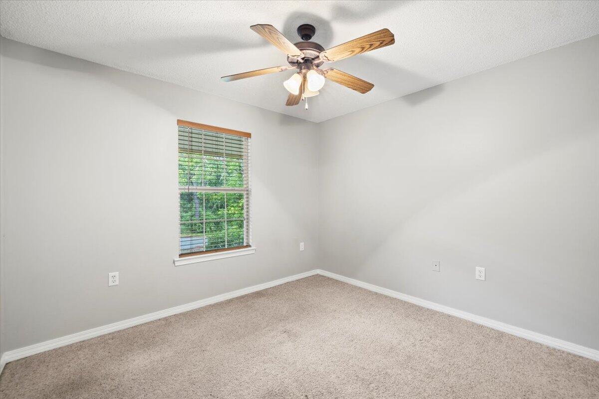 3140 Skyline Drive Crestview, FL 32539 - Photo 8 of 29 an empty room with a window and a fan
